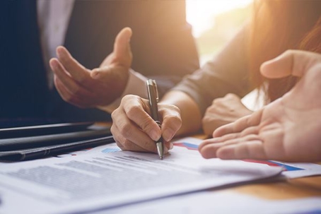 People signing paperwork